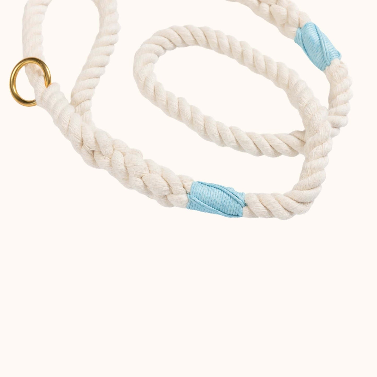 Natural rope lead with blue whipping and a gold clasp on a white background