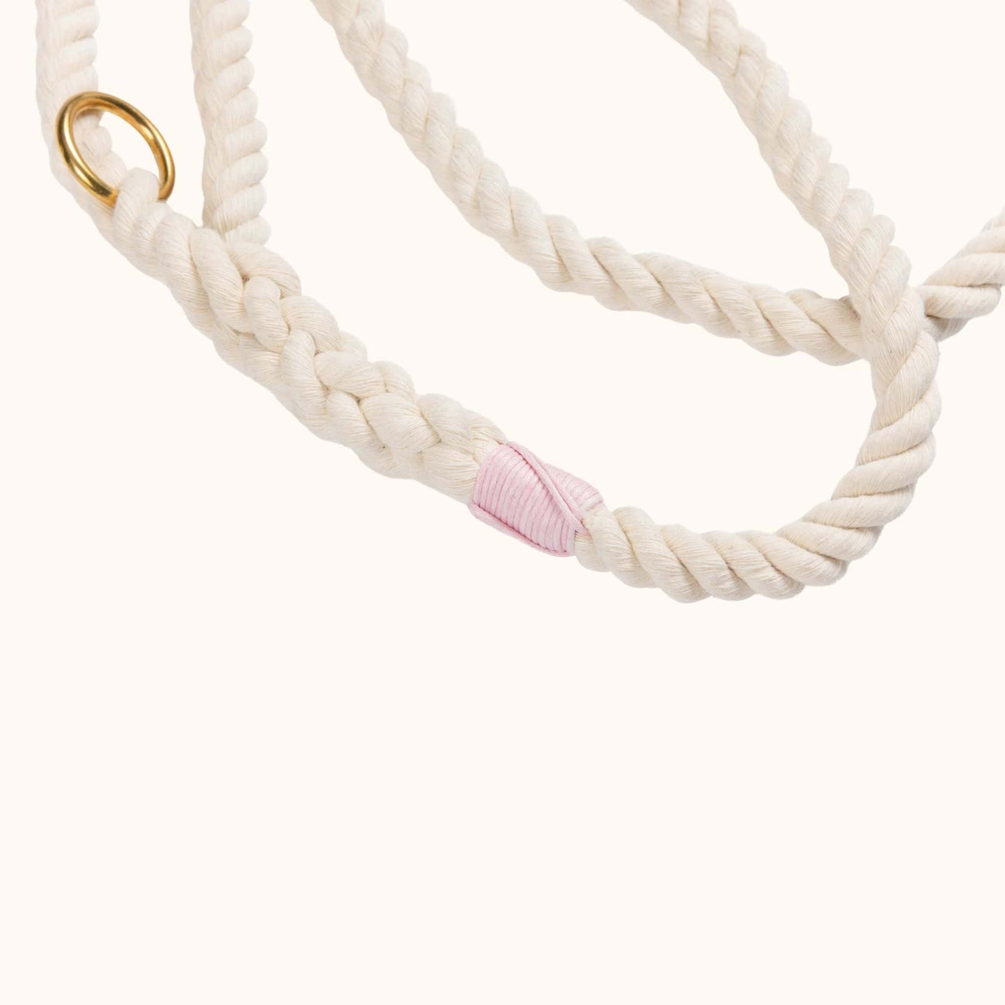 Close-up of a handmade natural cotton dog lead with light pink whipping.