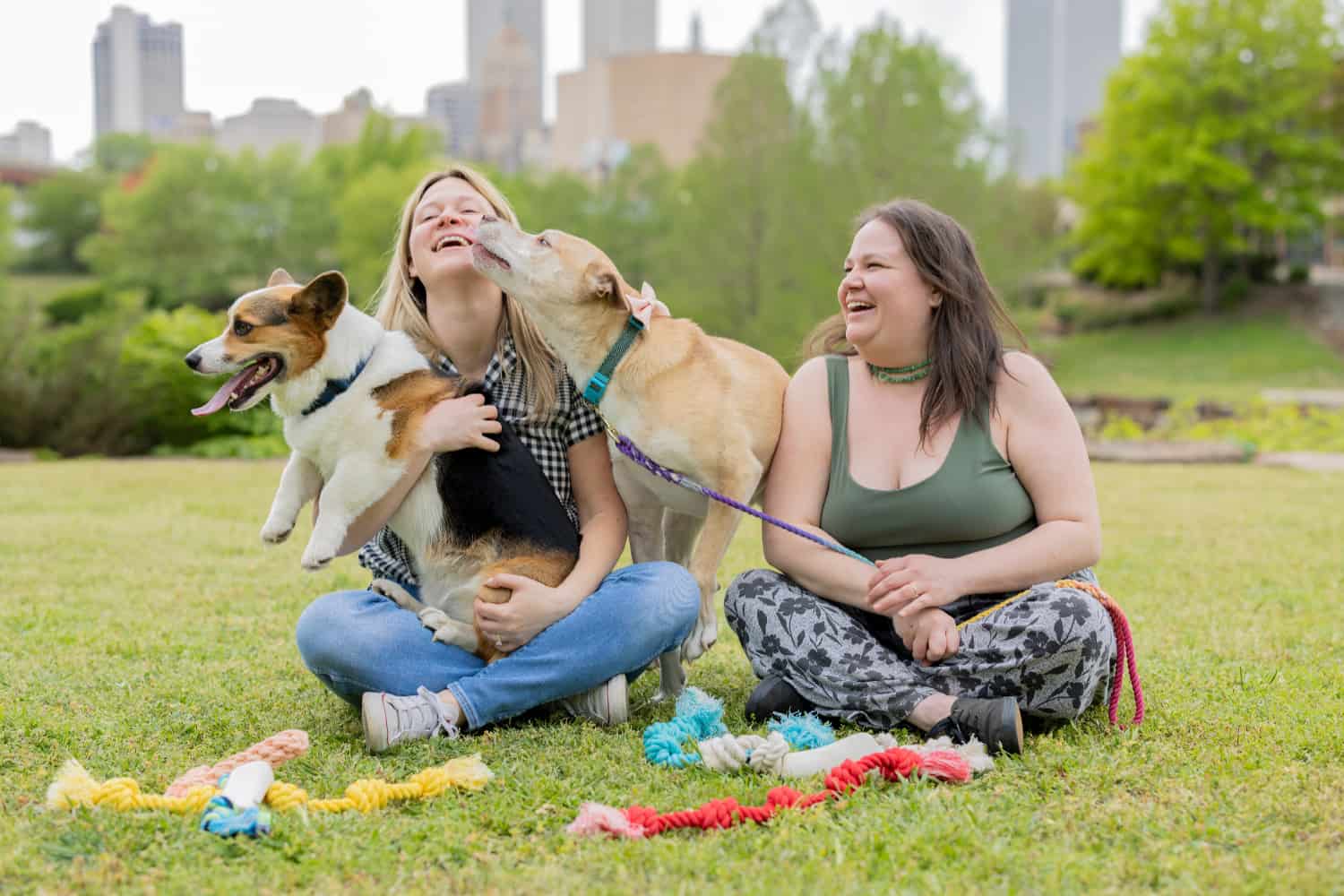 Knot Yours team sitting in a Tulsa park with their dogs and handmade rope toys