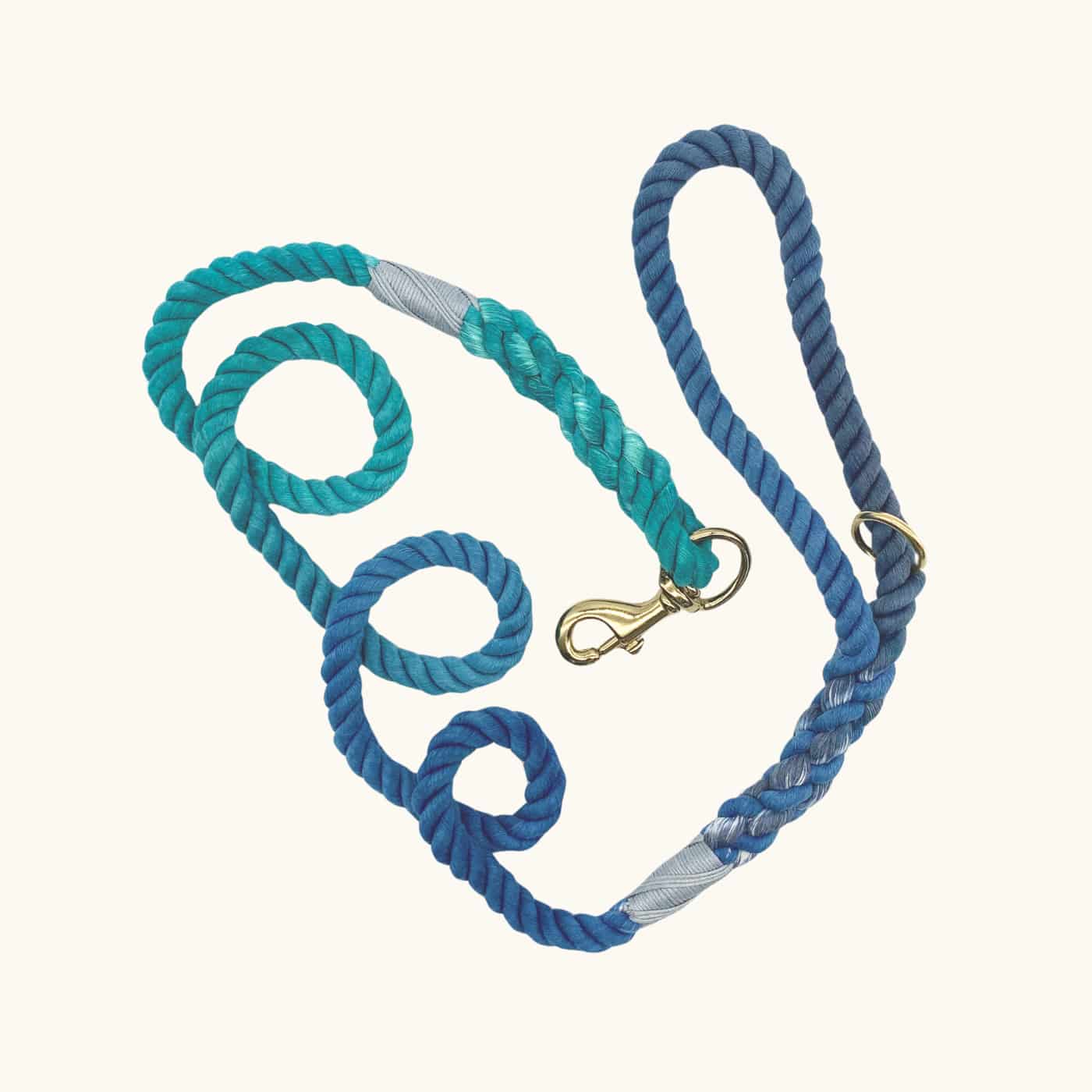 Hand-dyed rope dog leash in an ocean-inspired gradient of teal and navy blue, with brass hardware and reinforced wrap detailing.