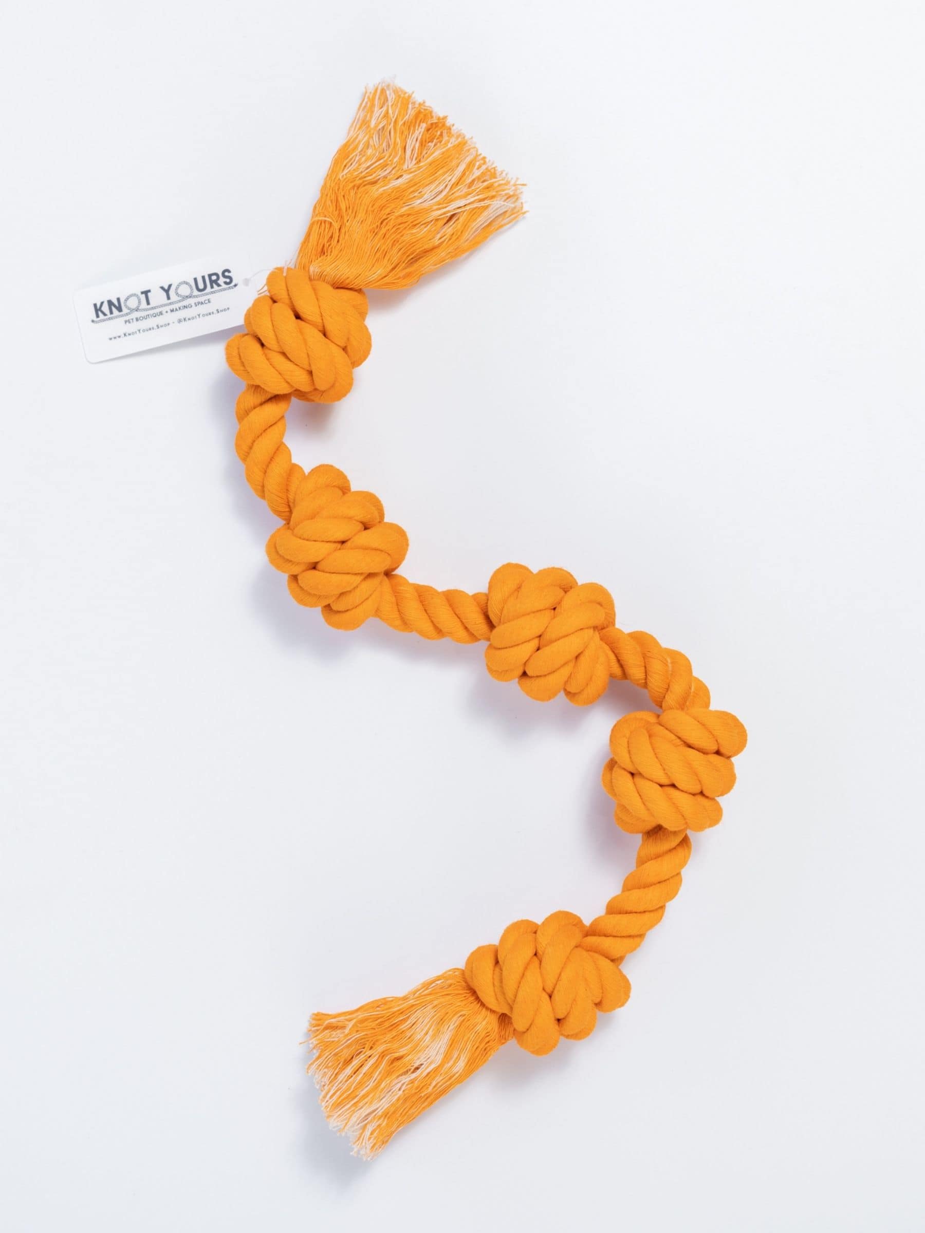 Bright orange Little Gigantic rope toy with five knots and tassles.