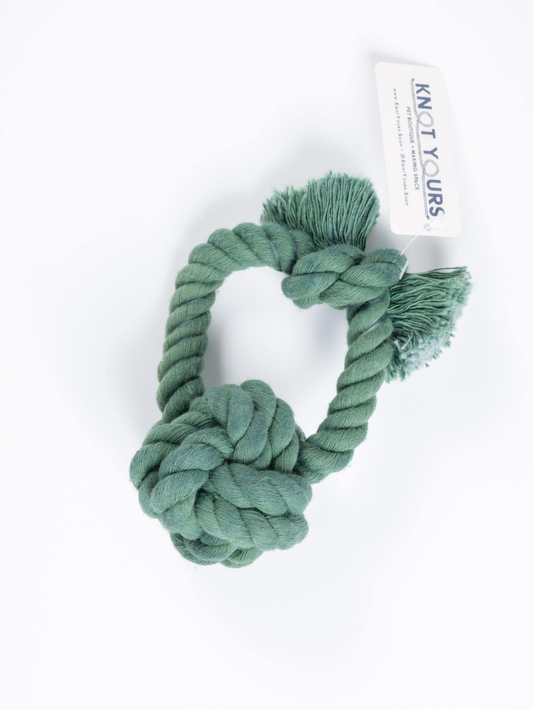 Green knotted rope dog toy with a monkey knot and loop handle.