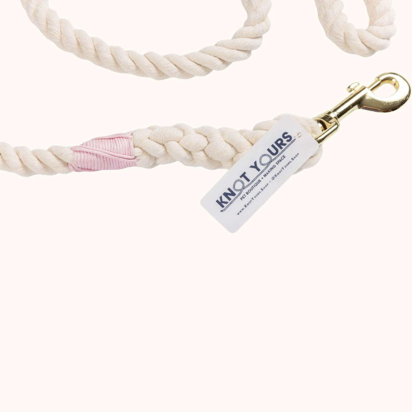 Handmade natural rope dog leash with light pink whipping and sturdy brass hardware