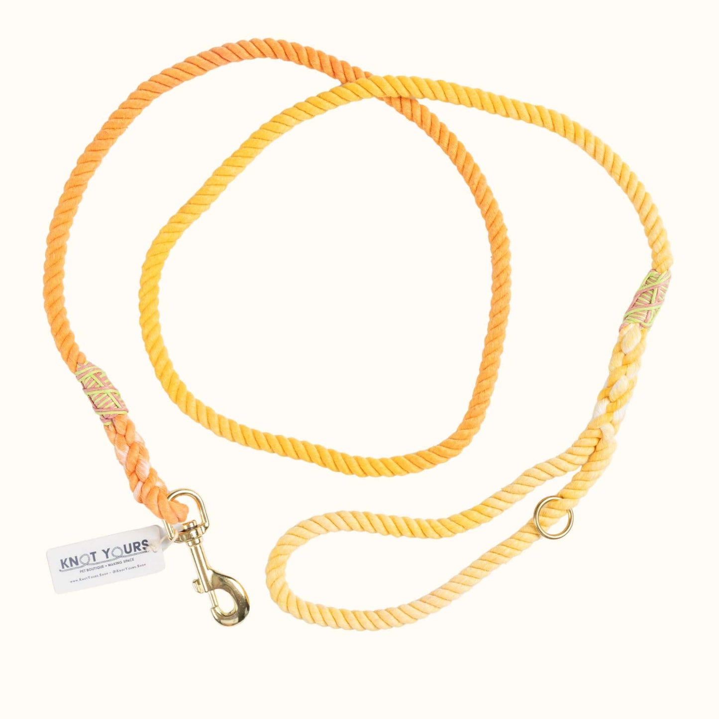 Yellow dog leash with gold clasp on a white background
