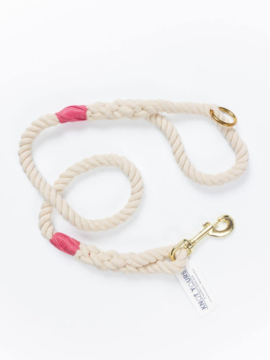 handmade natural rope dog leash with fuchsia whipping detail and brass clasp.