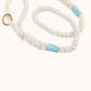 Natural rope lead with blue whipping and a gold clasp on a white background
