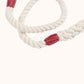Natural handmade rope leash with red whippings on a white background