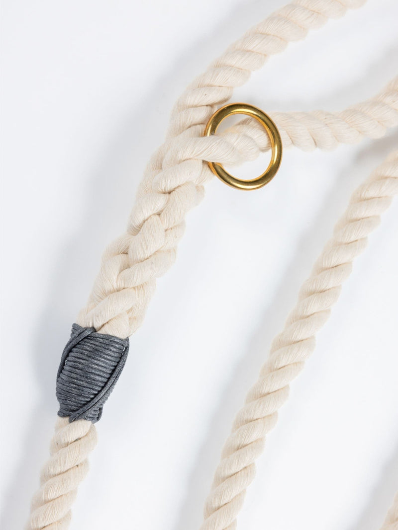 Natural custom made rope dog leash with a gold ring and gray knot on a white background