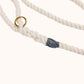 Natural custom made rope dog leash with a gold ring and gray knot on a white background