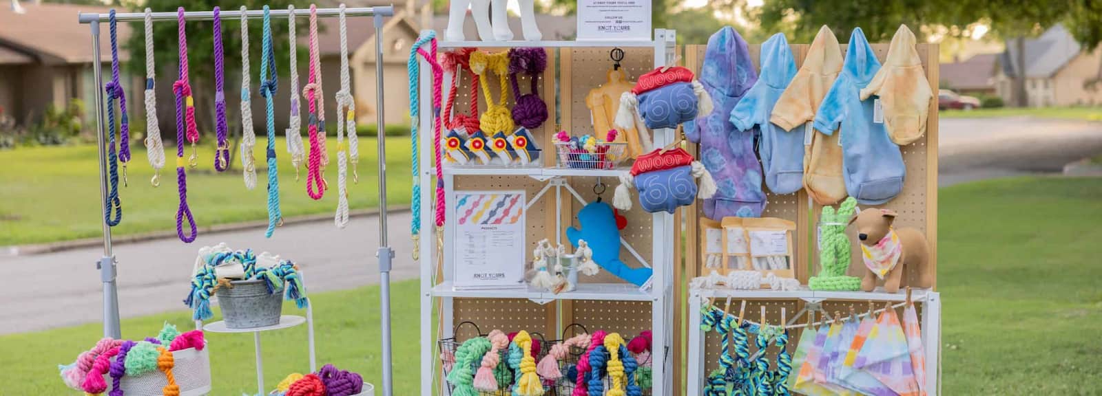 Outdoor display of hand made dog leashes, hoodies and toys made in the USA.
