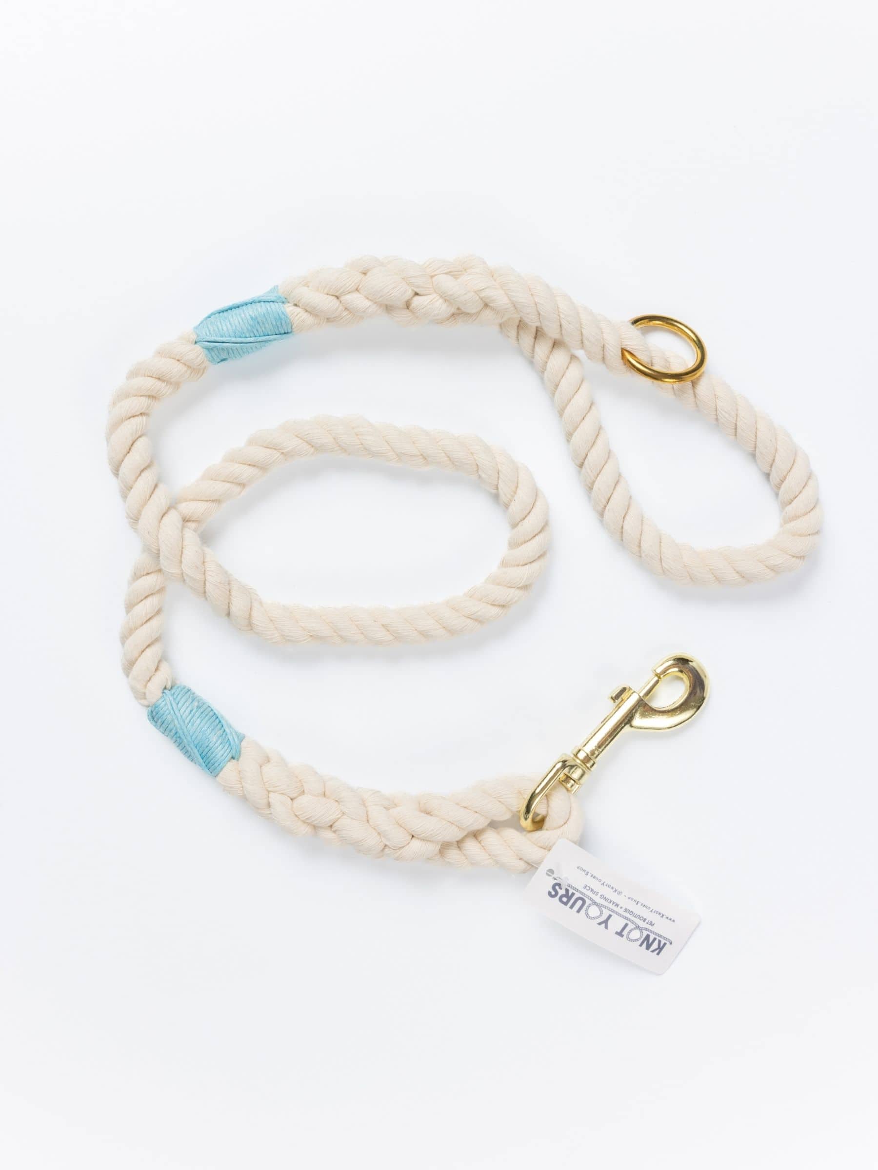 Handmade natural cotton dog leash with baby blue whipping and brass hardware.