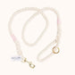 Custom natural rope dog leash with light pink whipping detail and brass clasp.