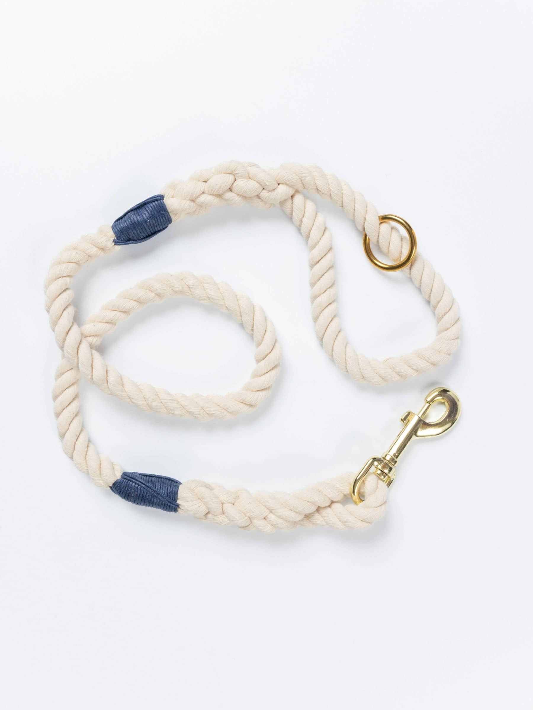 Handmade natural rope dog leash with navy blue whipping detail and brass clasp.