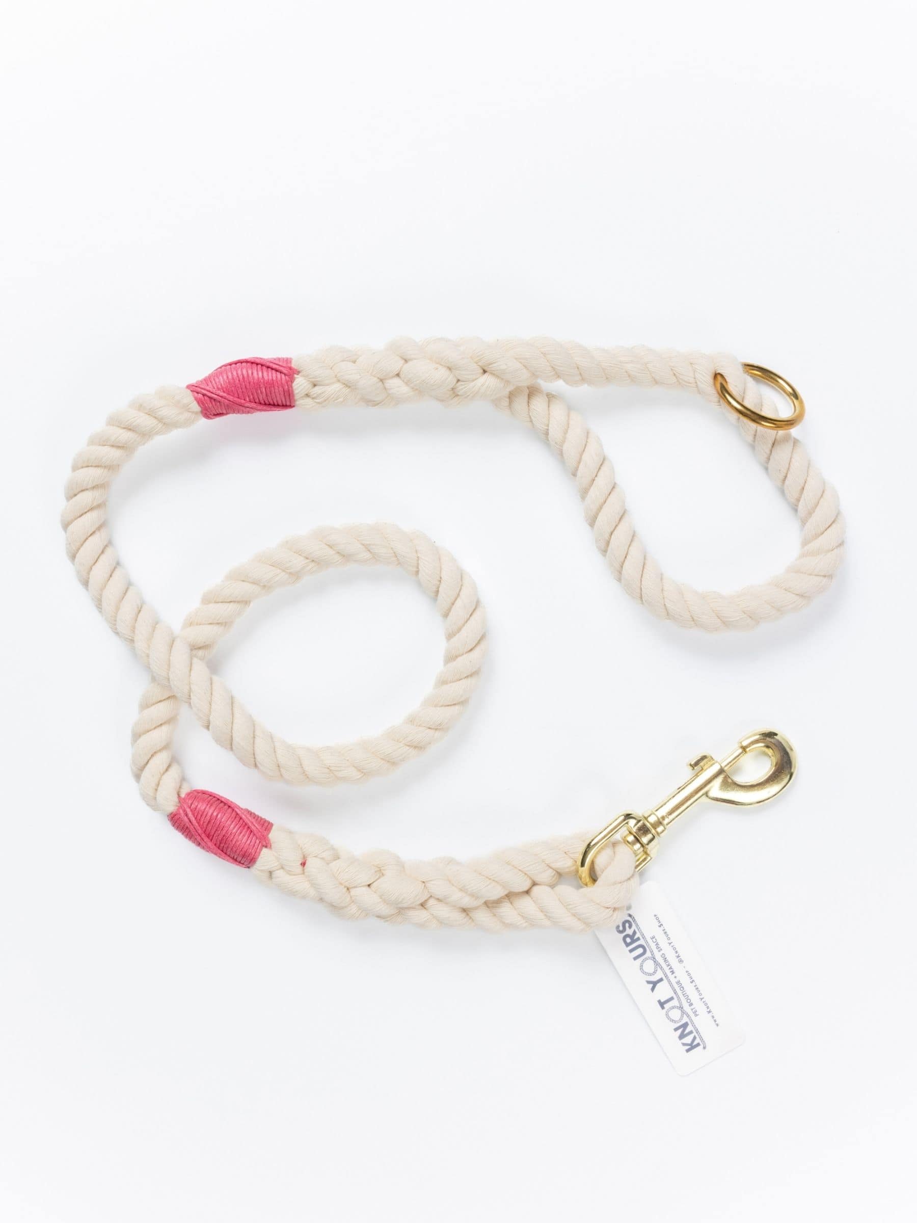 handmade natural rope dog leash with fuchsia whipping detail and brass clasp.