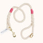 handmade natural rope dog leash with fuchsia whipping detail and brass clasp.