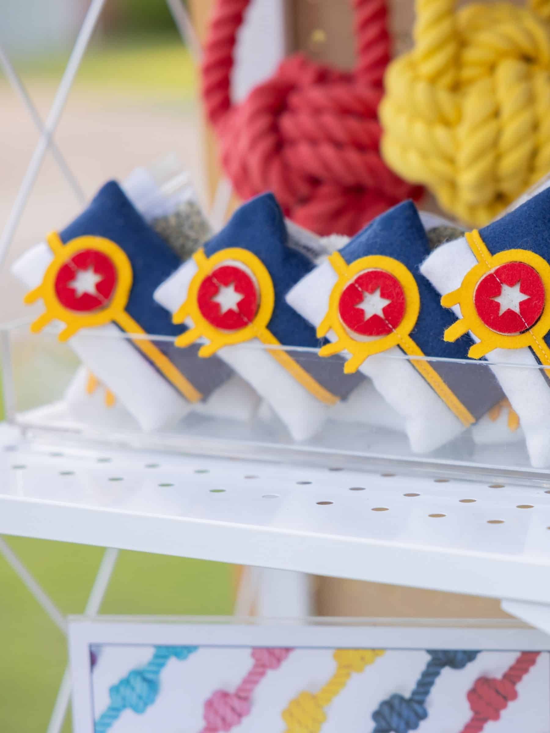 Four catnip pillows designed to look like the Tulsa flag arranged in a row on a shelf