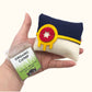 Hand holding Tulsa Flag Catnip Pillow in blue, white, and yellow felt design with included organic catnip refill pack, fun catnip toys for cats.