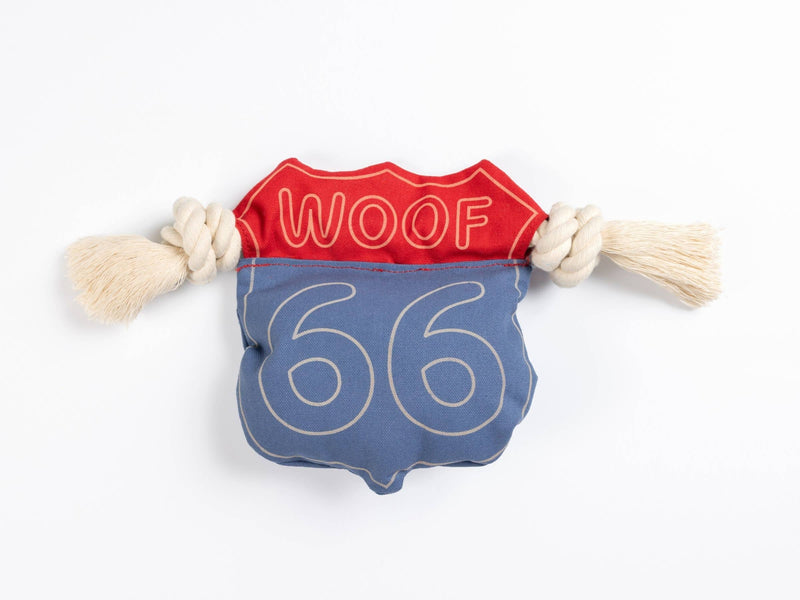 A dog chew toy made with blue and red canvas that has '66' and 'WOOF' text on it with rope knots on either side